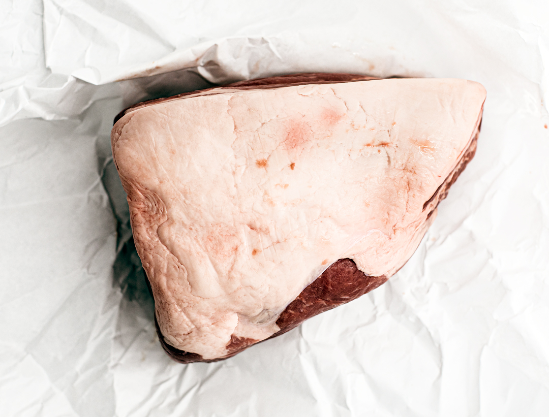 Overhead shot of pork butt in butcher's paper.