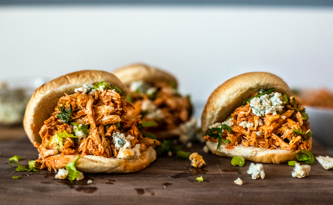Fresh buns topped with pulled Buffalo chicken, crumbled blue cheese, and chopped celery.