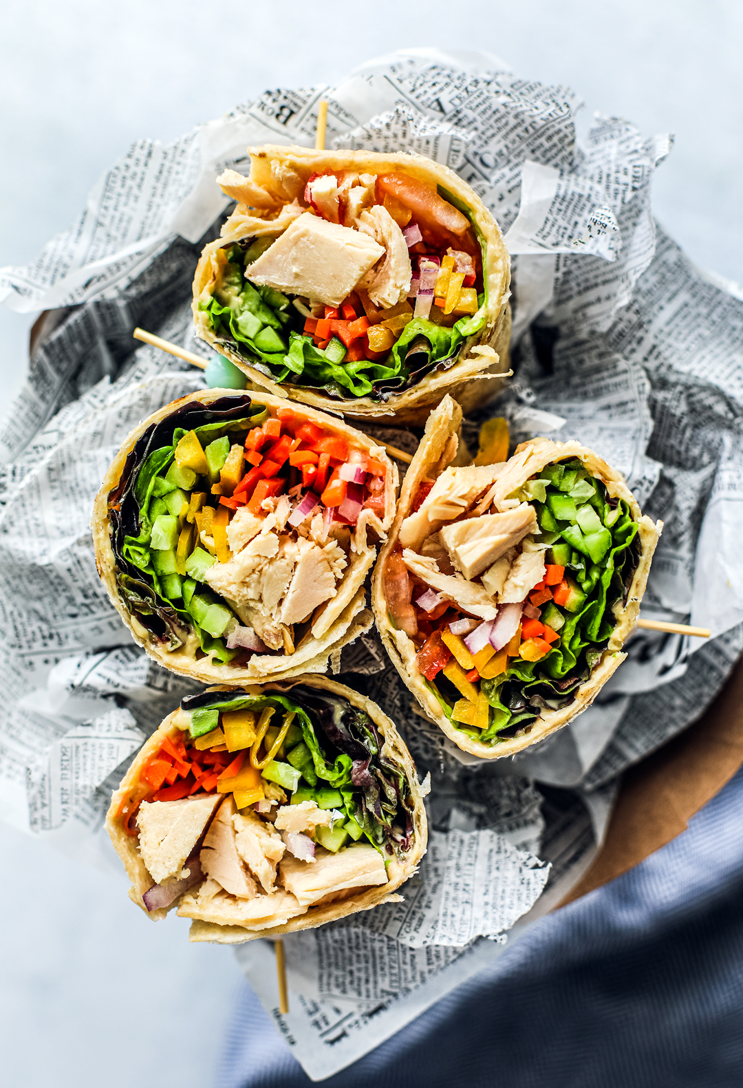 Overhead shot of colorful veggie-filled tuna wraps.