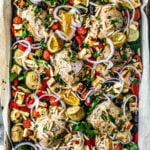 Overhead shot of sheet pan covered with roasted veggies, chicken, and feta.