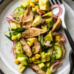 Overhead closeup of plate full of avocado and mackerel salad.