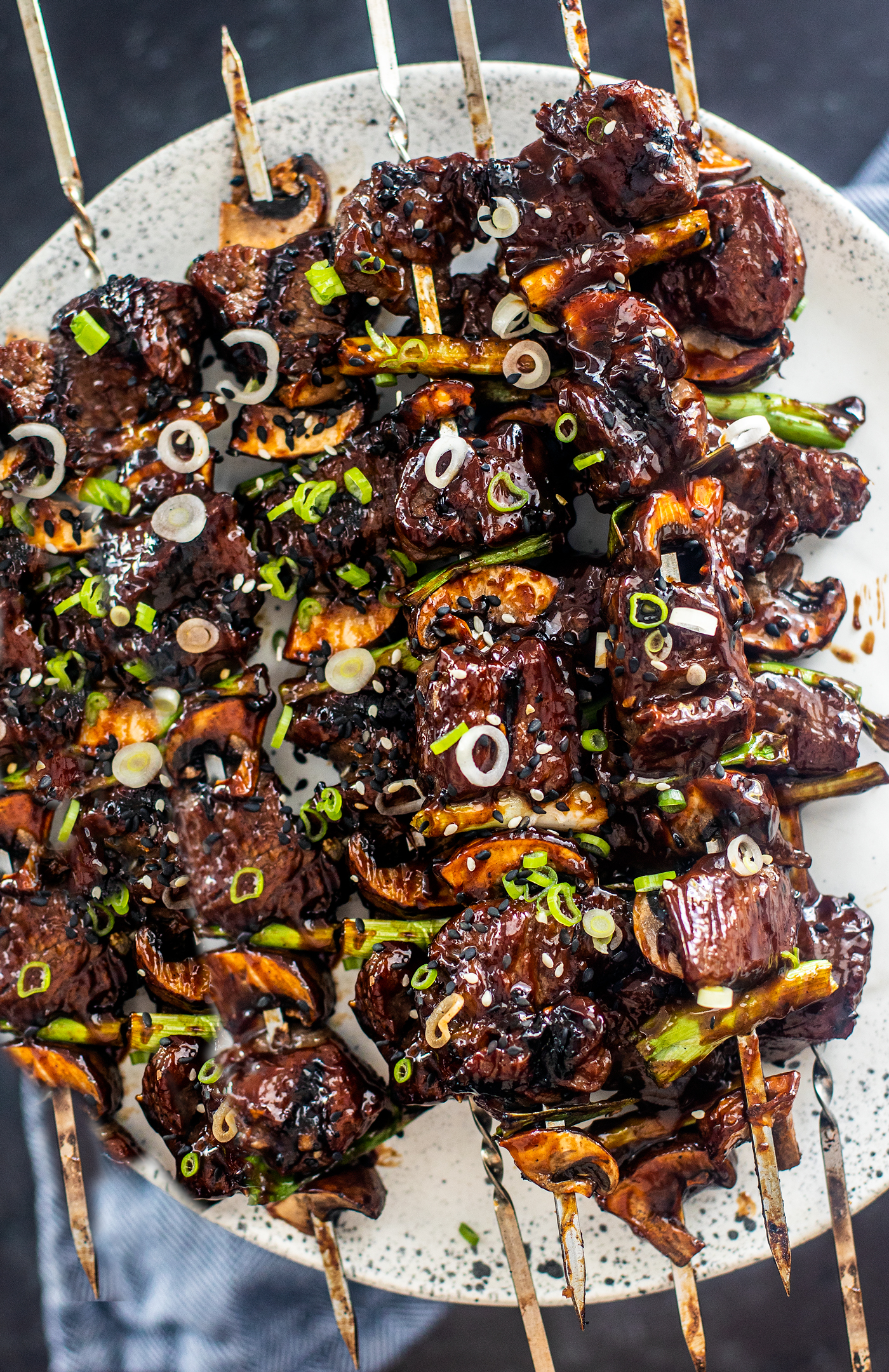 Overhead shot of serving plate full of Korean BBQ beef skewers.