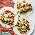 Fish tacos topped with mango salsa and jalapeño cream sauce.
