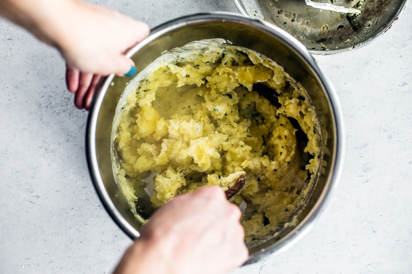 Mashed potatoes being stirred inside of Instant Pot.