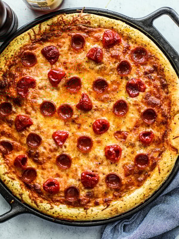 Peppadew pizza in round cast iron pan.