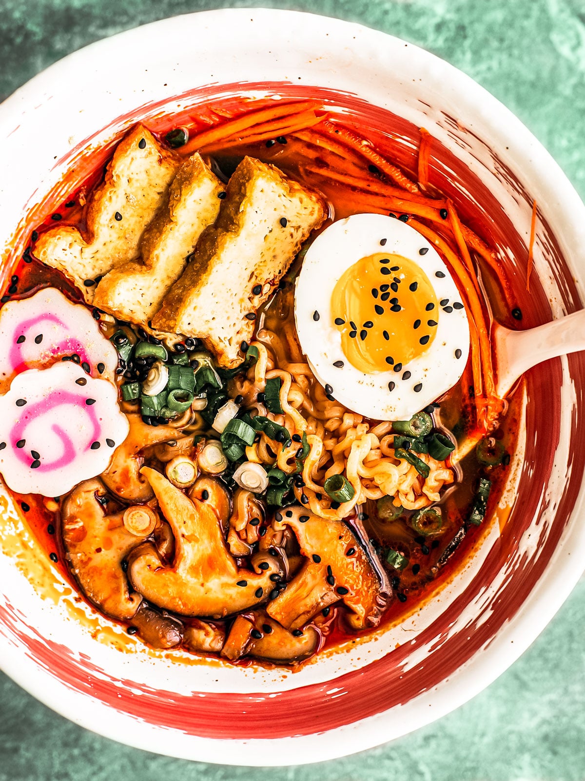 Spicy Shoyu Ramen in a ramen bowl with tofu and veggie garnishes.