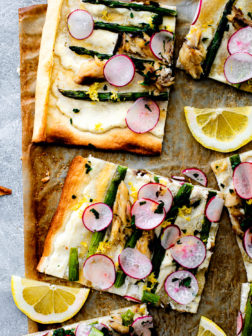 Cut up flatbread with asparagus, radishes, and mackerel.