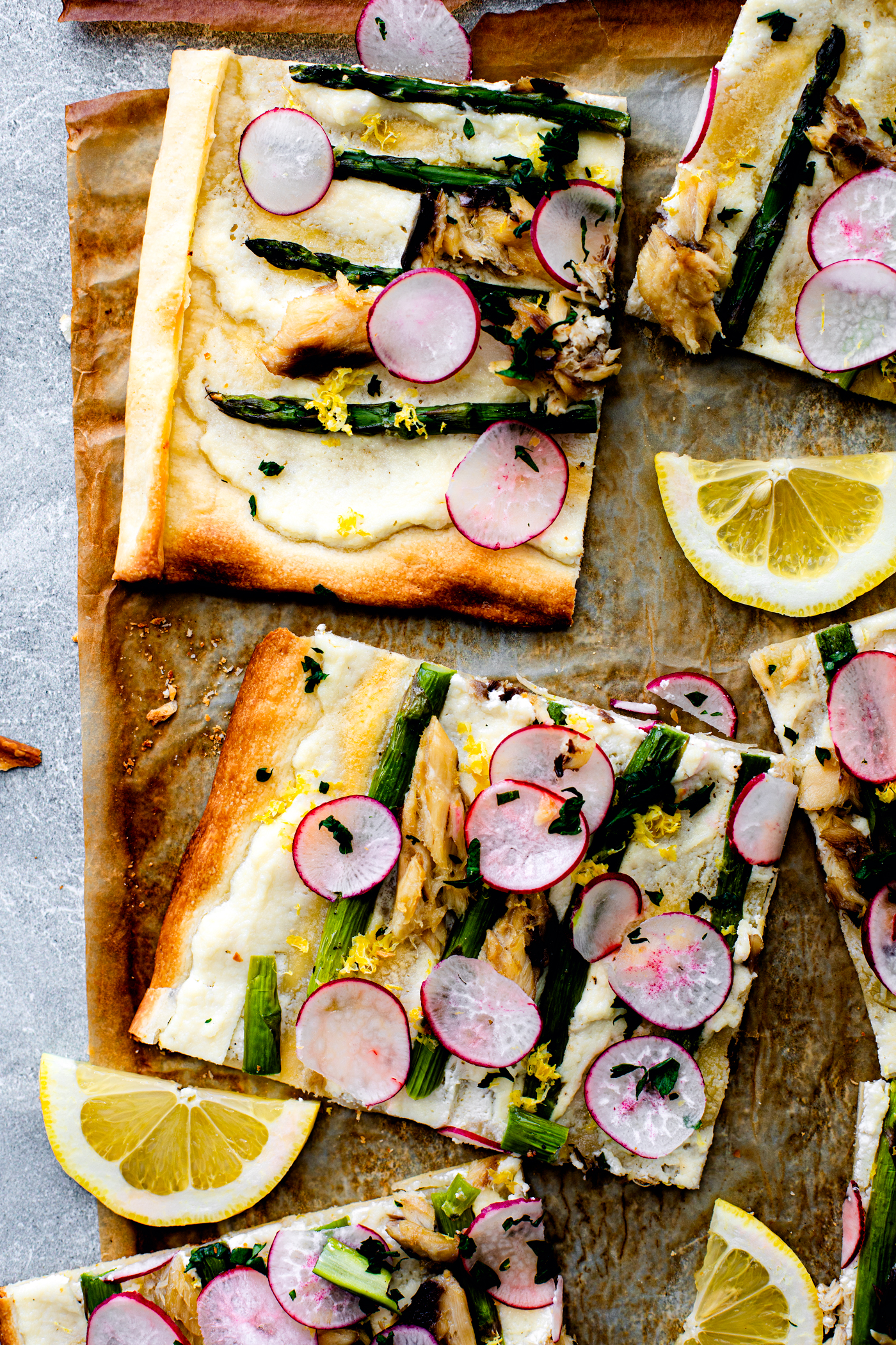 Cut up flatbread with asparagus, radishes, and mackerel.