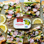 Slices of flatbread scattered around a tin of King Oscar mackerel.