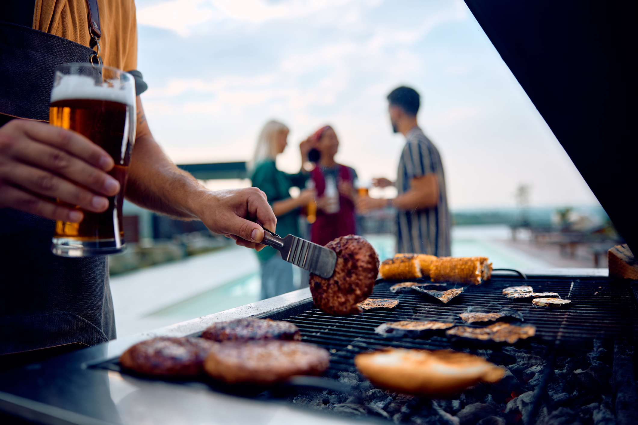 Meat being grilled at a pool party.