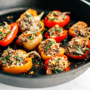 Side shot of stuffed peppers in cast iron pan.