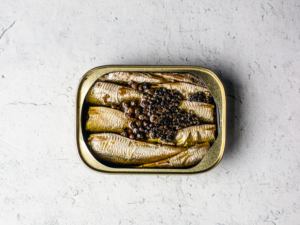 Opened can of cracked pepper sardines.