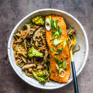 Bowl of noodles with miso salmon on top.
