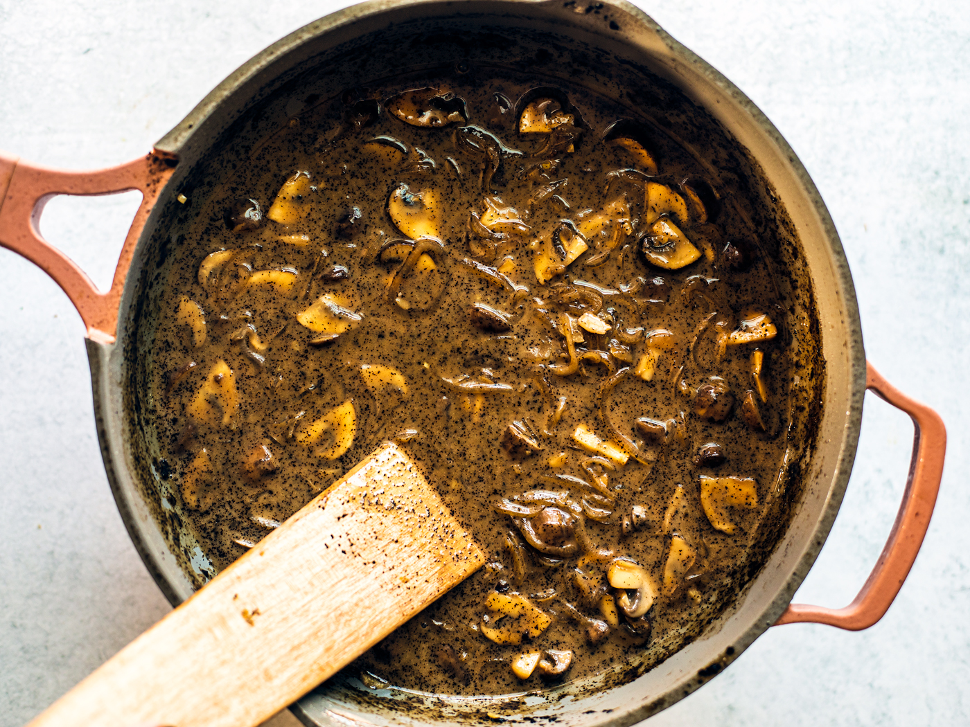 Pan of marsala gravy with mushrooms.