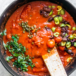 Red sauce with olives, fresh basil, and capers.
