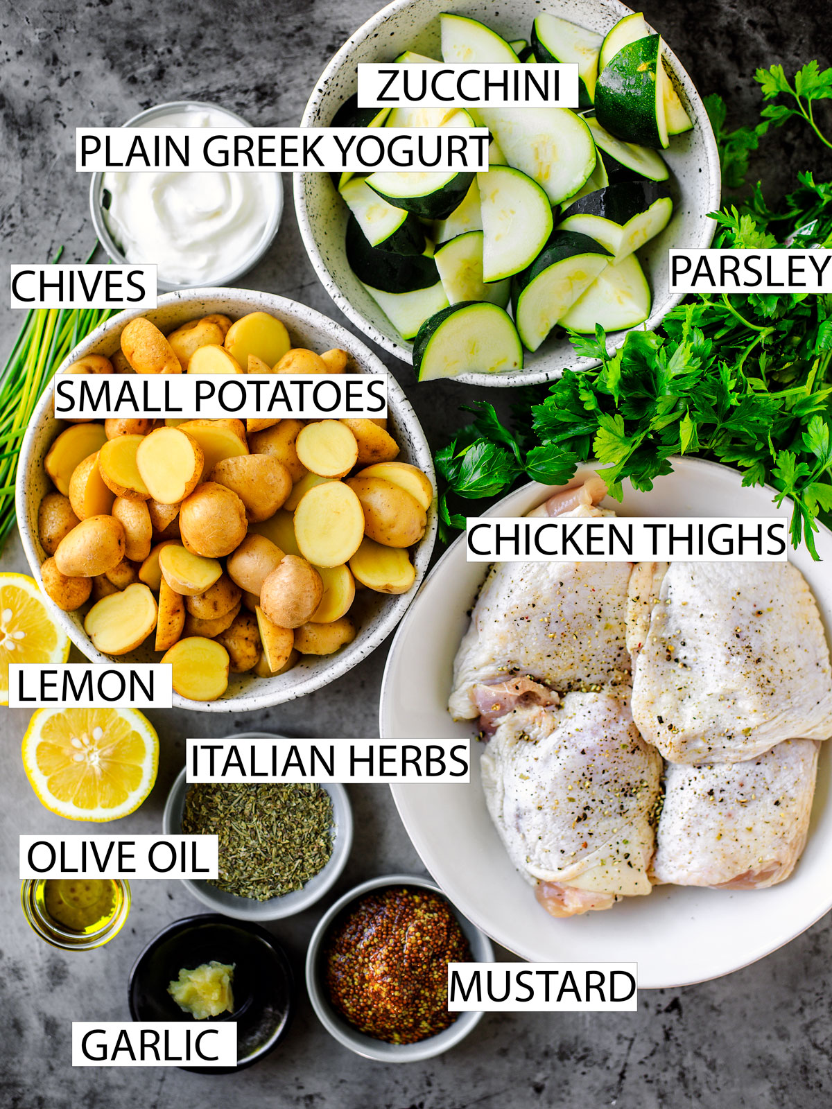 Spread of ingredients: chicken thighs, potatoes, herbs, mustard, oil, and yogurt.