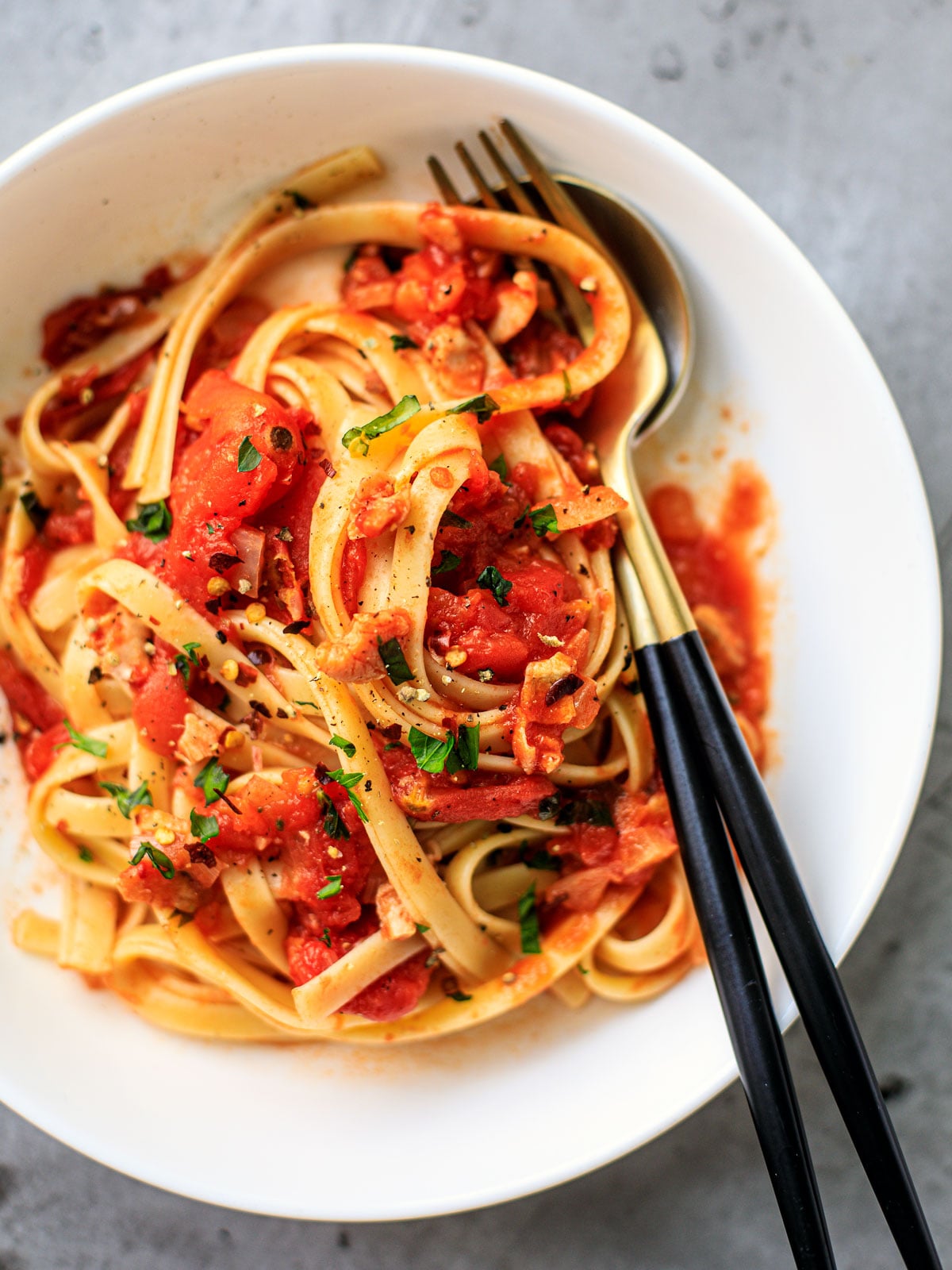 Close up of pasta with clams and tomatoes.