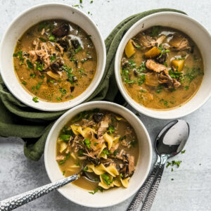 Three bowls of chicken marsala soup.