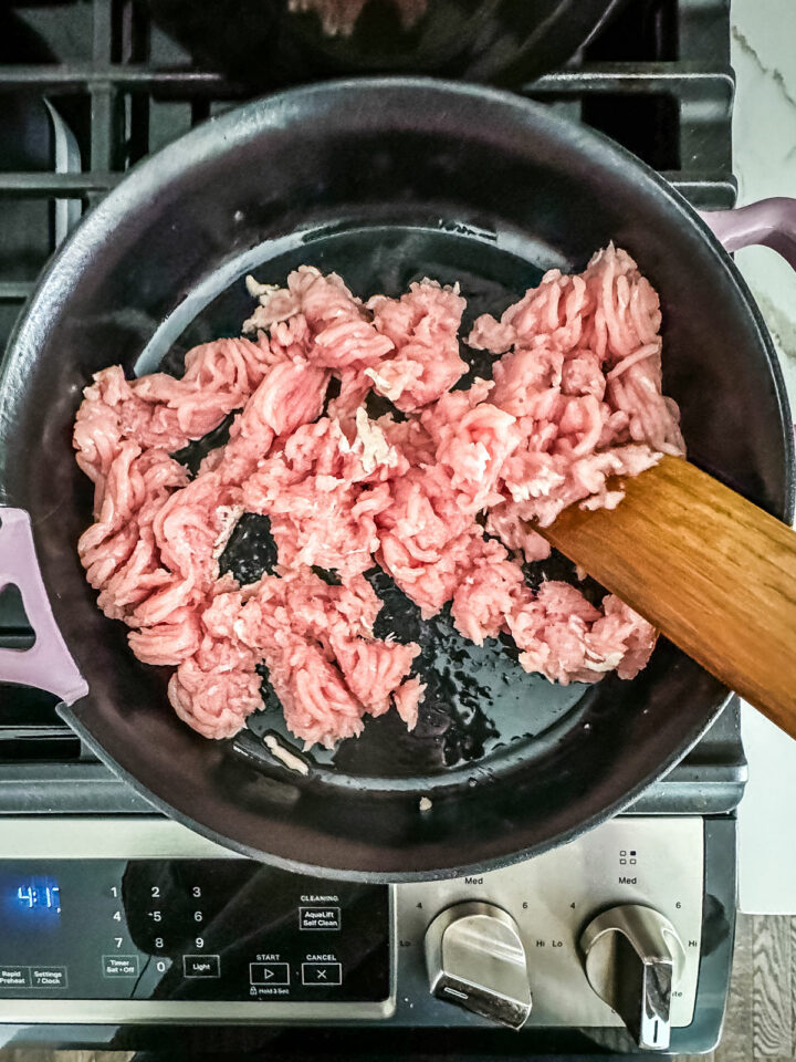 Raw ground turkey in a pan over the stove.
