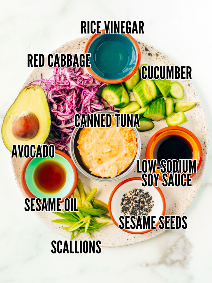Ingredients for high-protein tuna bowl on a white marble counter.