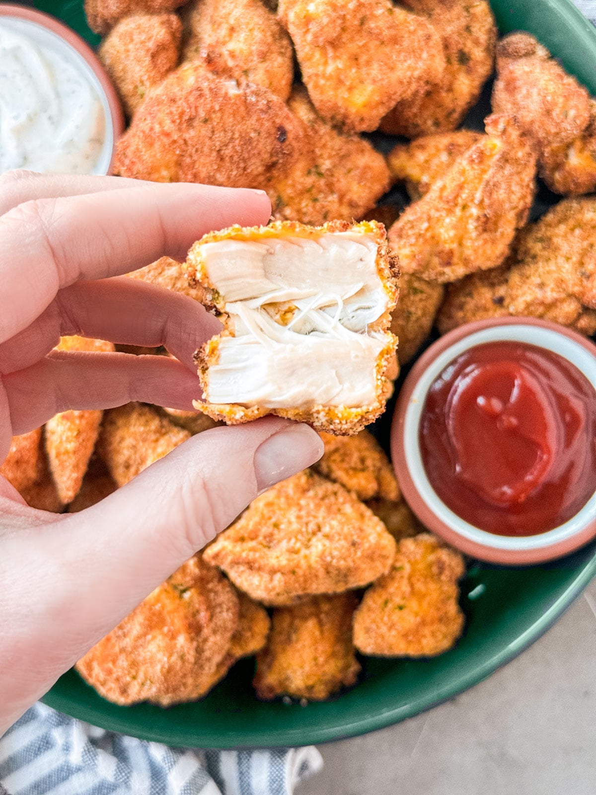 Chicken nugget broken in half to reveal tender meat.