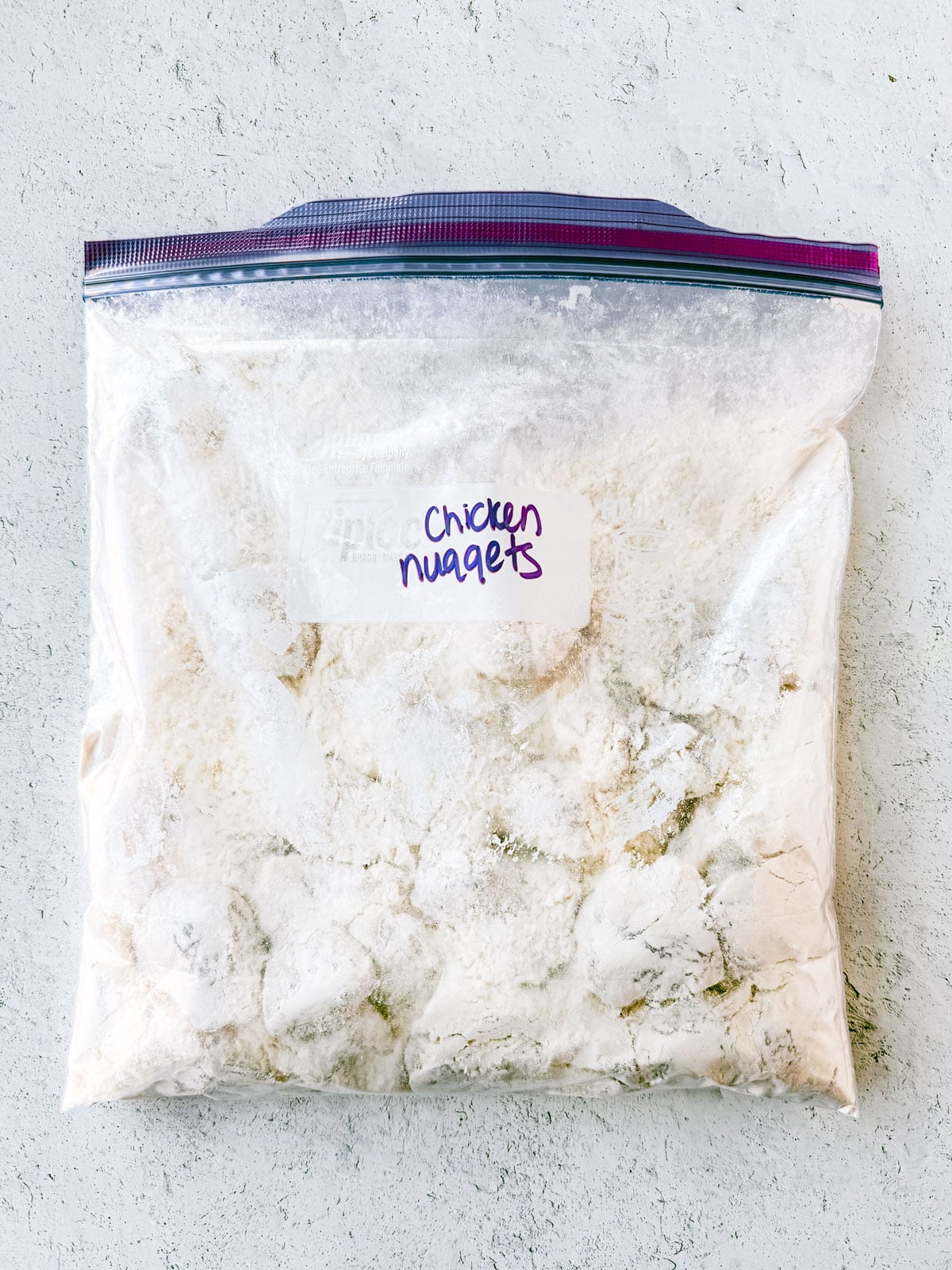 A zip-top bag of chicken nuggets shaken in flour.