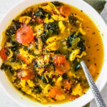 Bowl of chicken soup with turmeric and ginger.