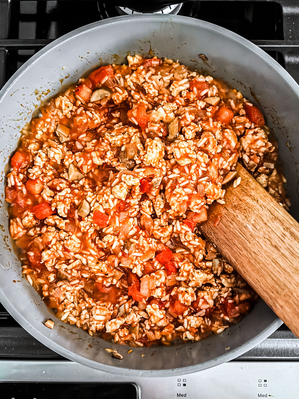 Tomatoes, ground turkey, and rice mixed together in a skillet.