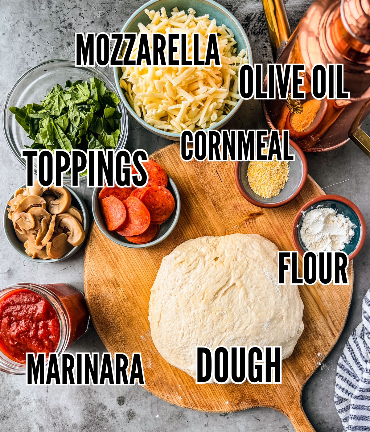 Ingredients for cast iron pizza on a dark grey background.