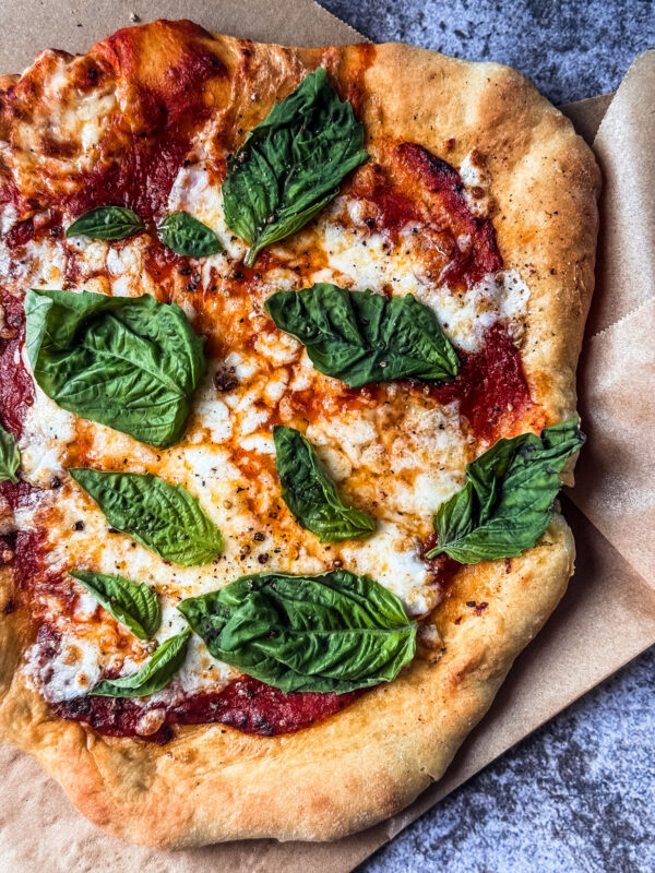 Air fryer pizza with fresh basil.