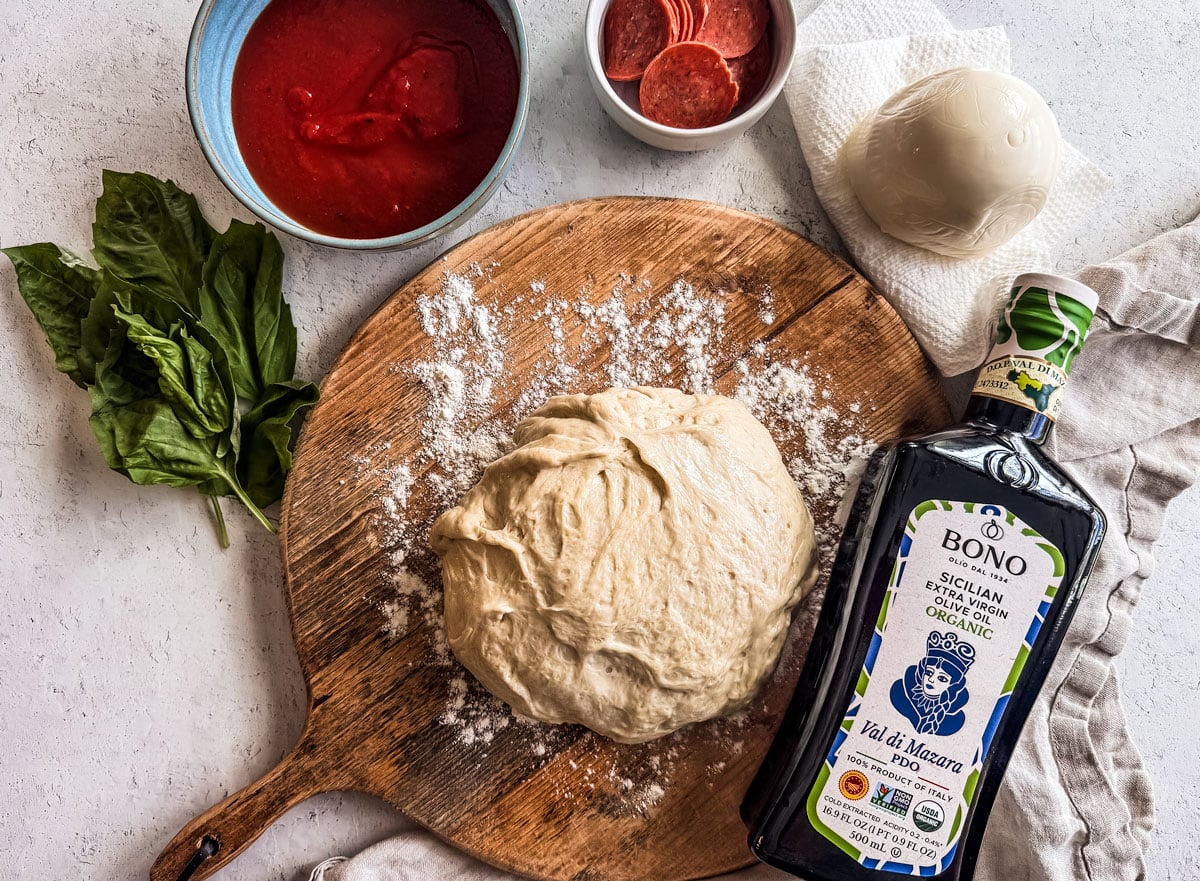 Ingredients for air fryer pizza on a white background.