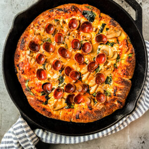 Pizza in cast iron skillet.