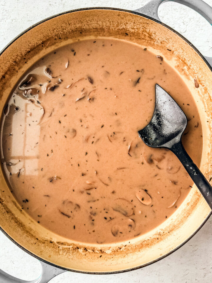 A pan full of nicely formed creamy mushroom sauce.