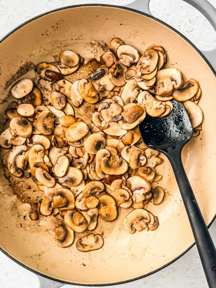 Cooked down mushrooms in a pan.