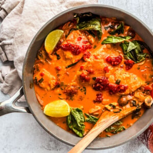 Sauté pan of curry salmon in coconut milk.