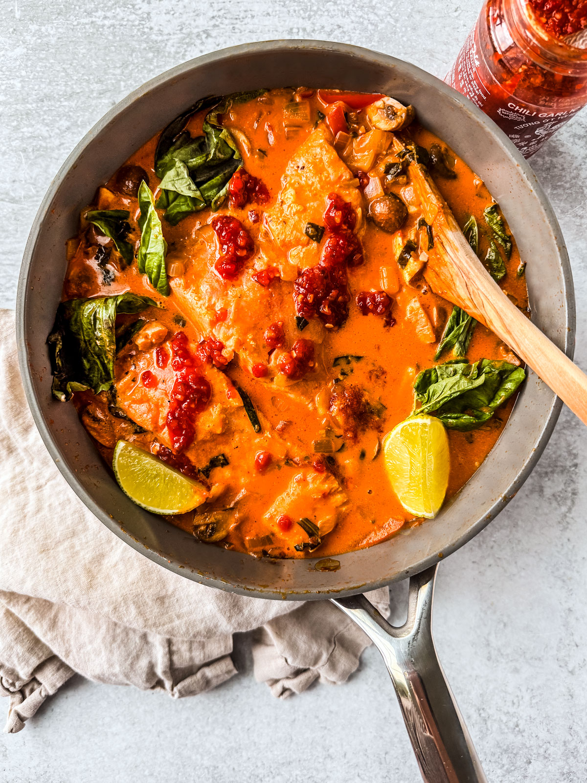 Sauté pan with curry salmon with coconut milk and lots of veggies.