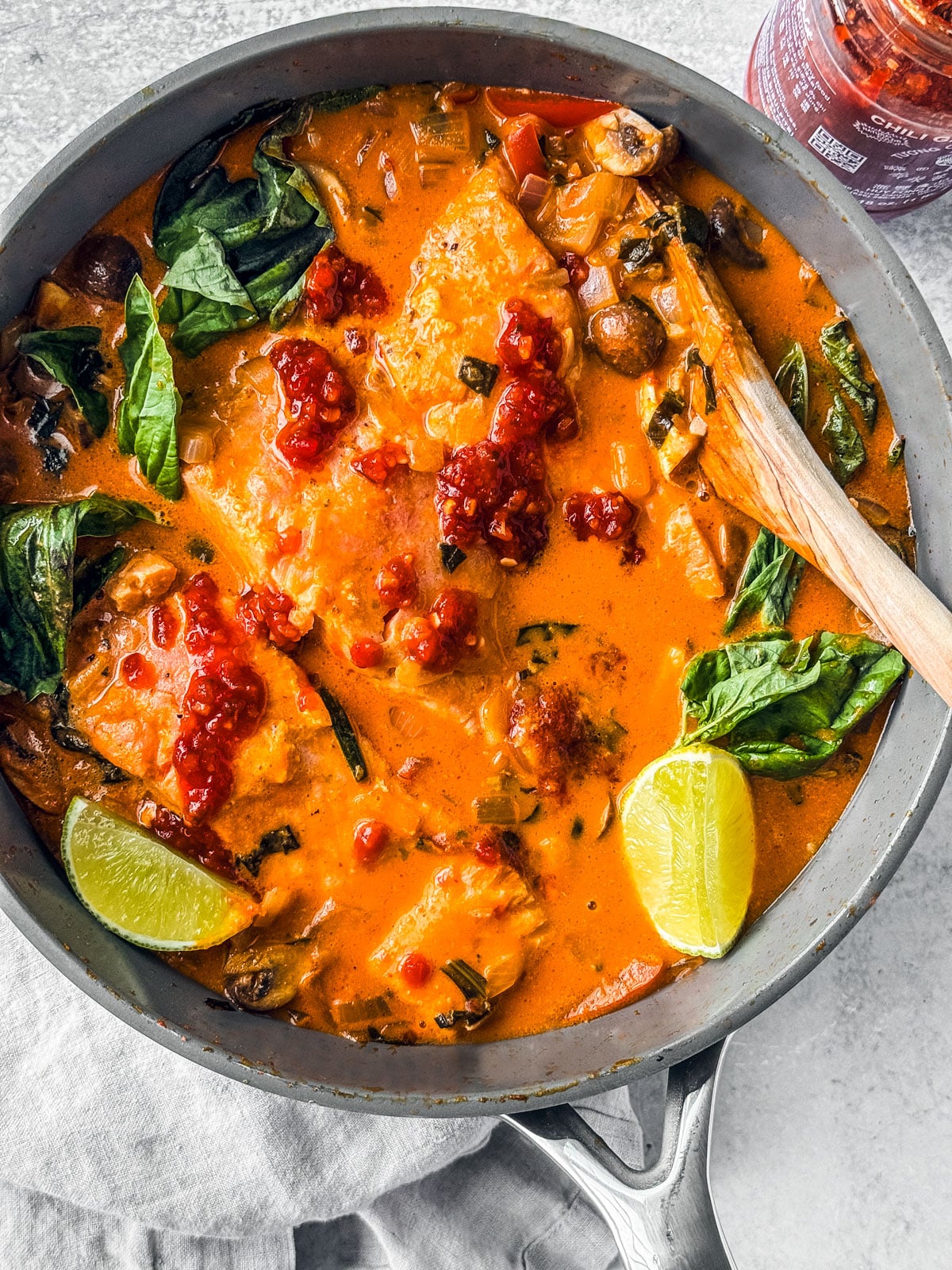 Sauté pan with curry salmon with coconut milk and lots of veggies.