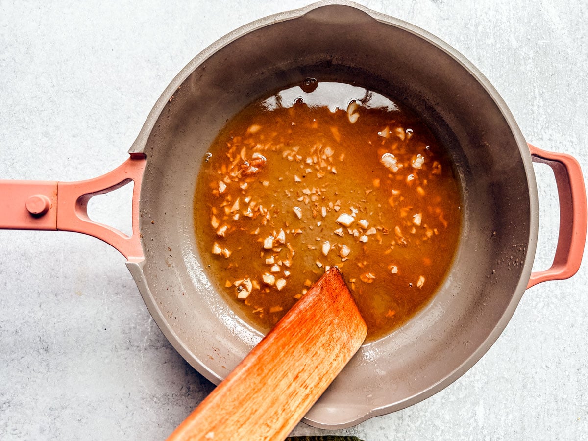Minced garlic and wine in a pan.