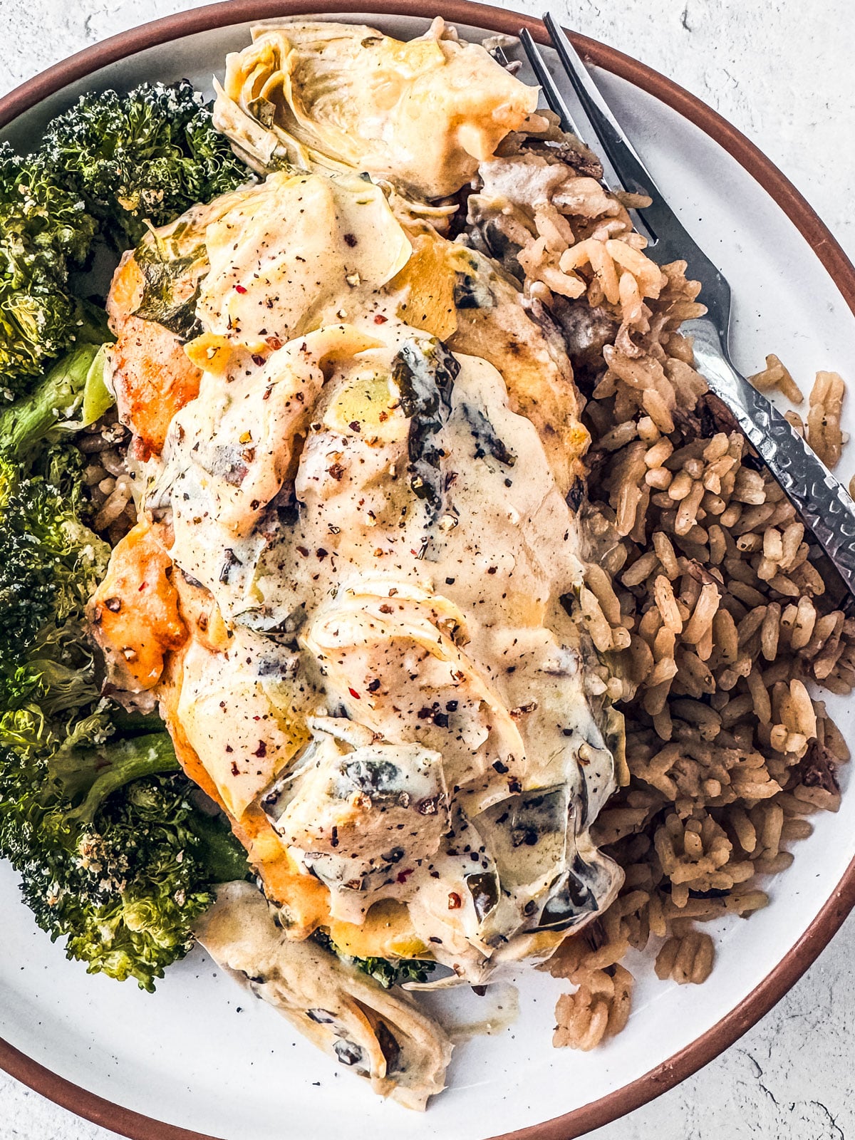 Spinach artichoke chicken over broccoli and rice.