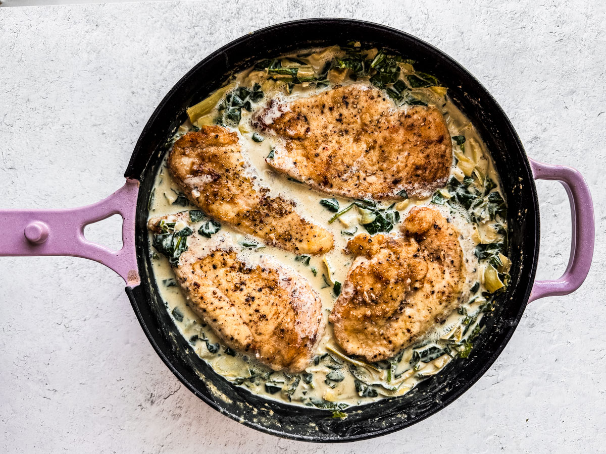 Chicken cutlets nestled into spinach and artichoke sauce.