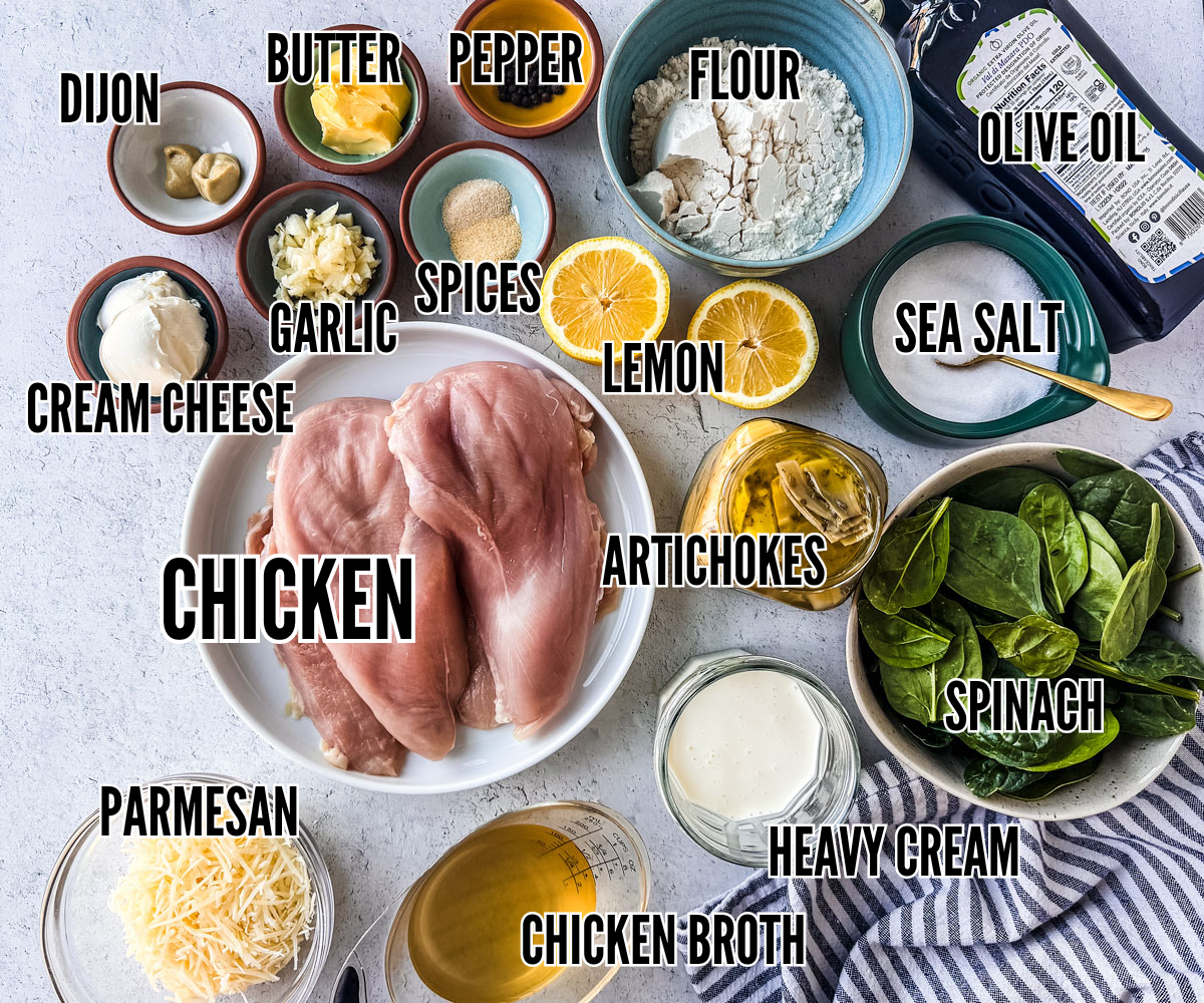 Ingredients for spinach artichoke chicken skillet dinner on a light background.