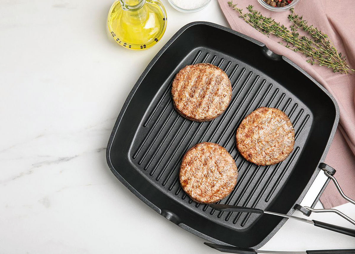 Chicken burger patties on a grill pan.