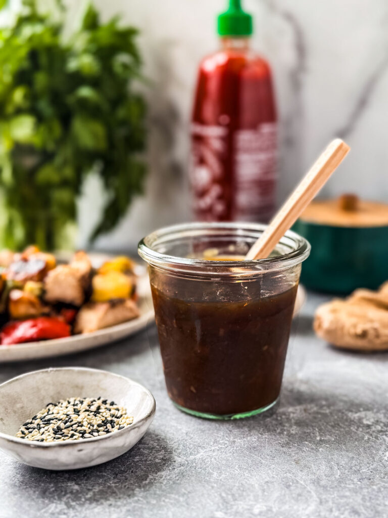 Teriyaki sauce in a jar on a countertop.