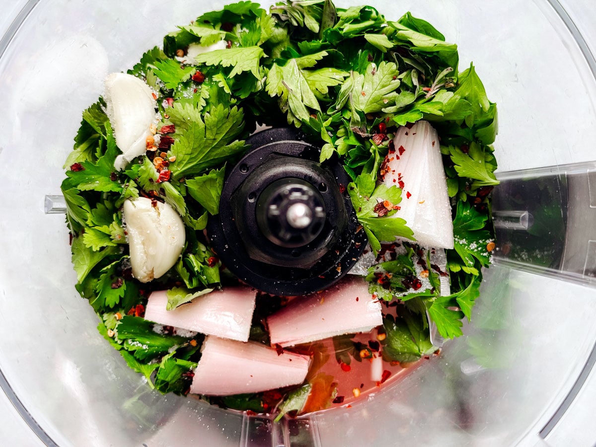 Fresh ingredients in a food processor bowl.