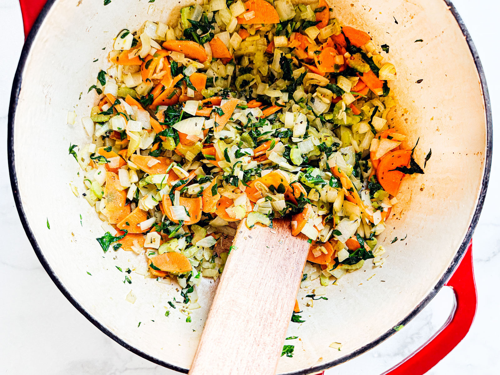 Pot with cooked down and wilted veggies.