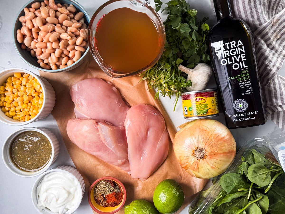 Ingredients for white chicken chili on a marble countertop.