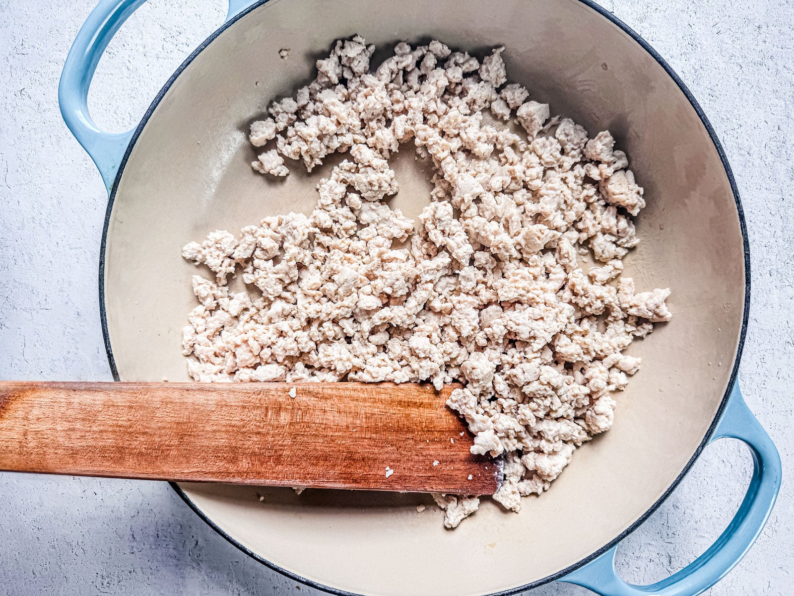 Skillet of cooked ground chicken.