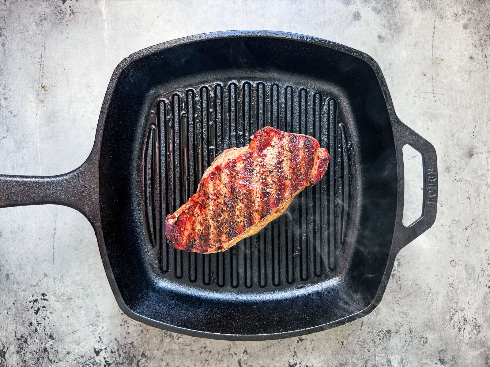 Steak on a grill pan with nice grill marks.