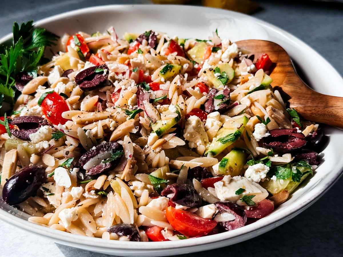 Mediterranean orzo pasta salad in a serving bowl. 
