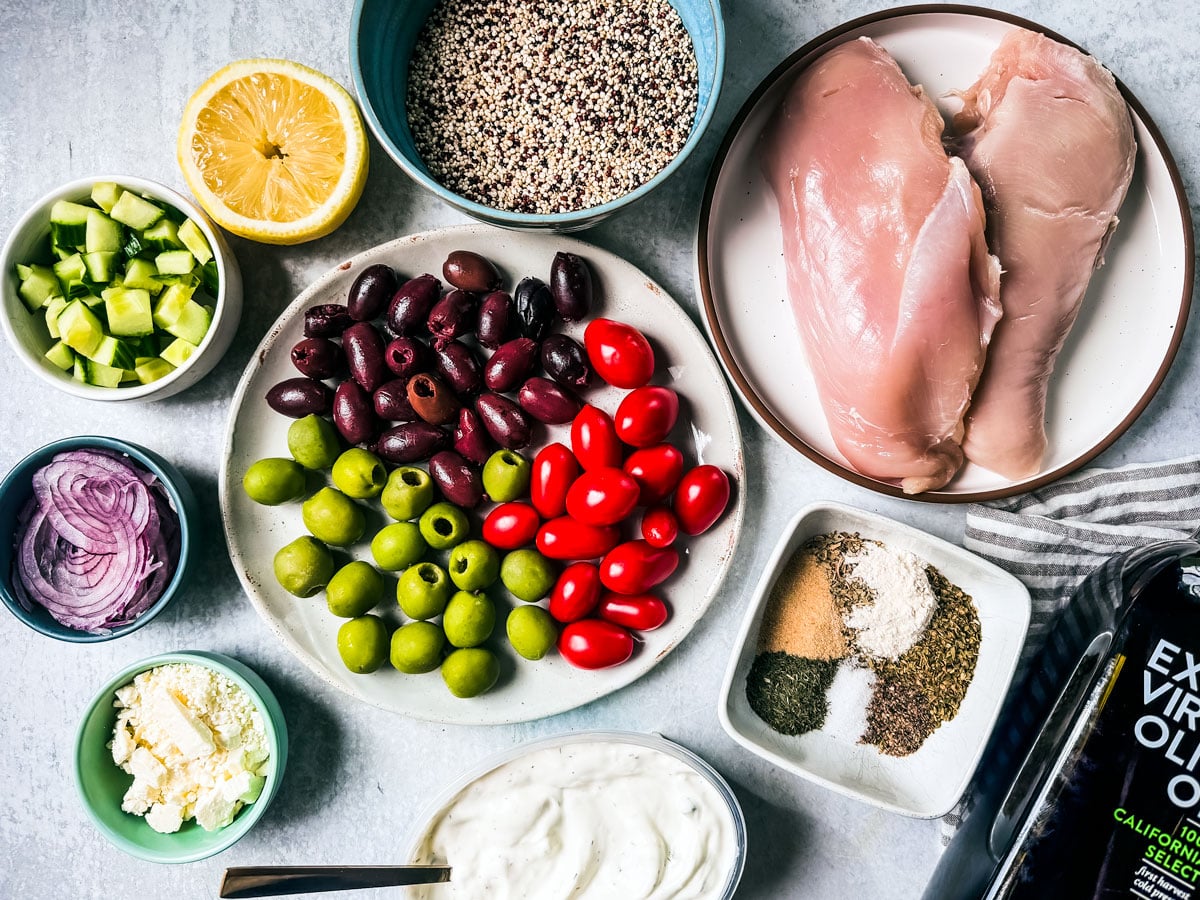 Ingredients for Greek Quinoa Bowls on a white background.